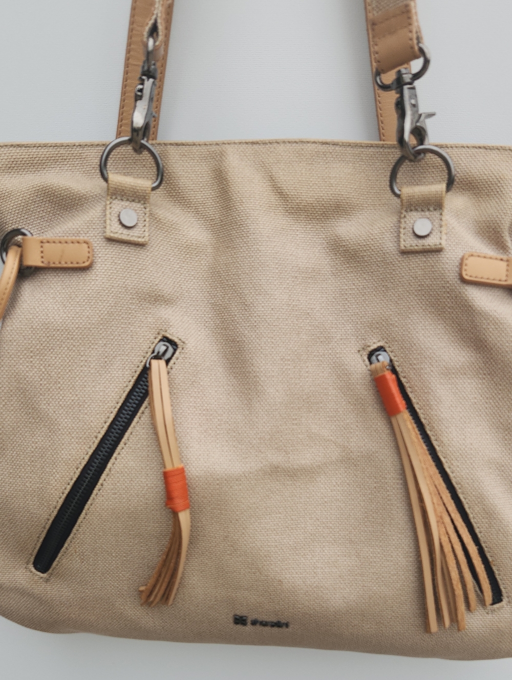 Sherpani Beige Canvas Shoulder Bag with Tan Accents and Orange Tassels